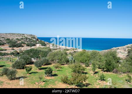 Agricultural fields and rural landscape along Mgiebah Valley, leading all the way down to Mgiebah Bay, near Selmun, Malta, in the Mediterranean Sea. Stock Photo