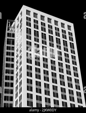 A vertical grayscale low angle view of a modern housing estate on the dark background Stock Photo