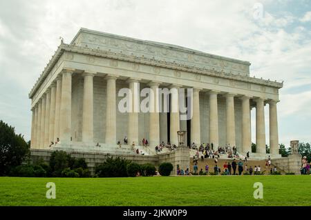 A beautiful view of the exterior of the Lincoln Memorial in Washington DC on grass against a light blue sky Stock Photo