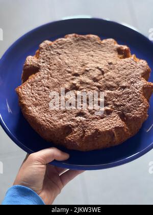 yogurt cake freshly baked and placed in a blue plate for presentation. quick and easy recipe to prep Stock Photo