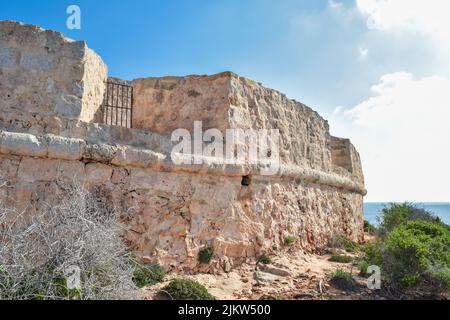 The outer wall of Santa Marija Battery, a coastal battery built by the knights of the Order of St John to protect the coast of Comino Island in Malta Stock Photo