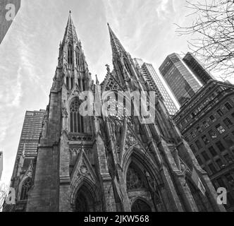 A low angle shot of St. Patrick's Cathedral in New York, the USA in cloudy sky background Stock Photo