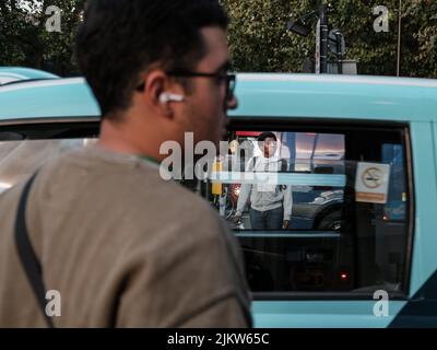 A closeup shot of people waiting for green traffic light in London, UK Stock Photo