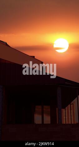 A mesmerizing view of a moon in the dark sky at night over a city Stock Photo