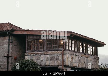 An exterior of an old rural house against cloudy sky Stock Photo