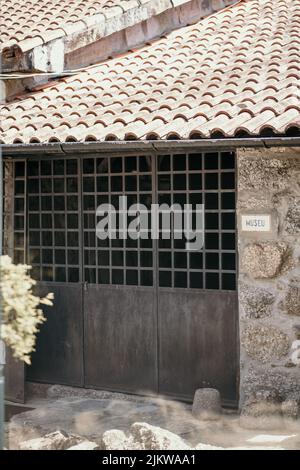 A vertical shot of an old building with a garage in a village Banque D'Images
