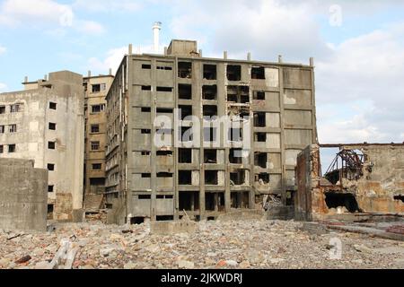 Ruins of old buildings on Hashima Gunkanshima island near Nagasaki in Japan Stock Photo