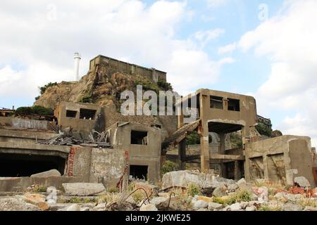 Ruins of old buildings on Hashima Gunkanshima island near Nagasaki in Japan Stock Photo