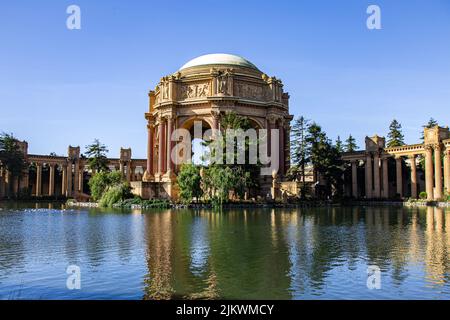 A beautiful view of The Palace Of Fine Arts reflecting on a lake under a blue sky Stock Photo