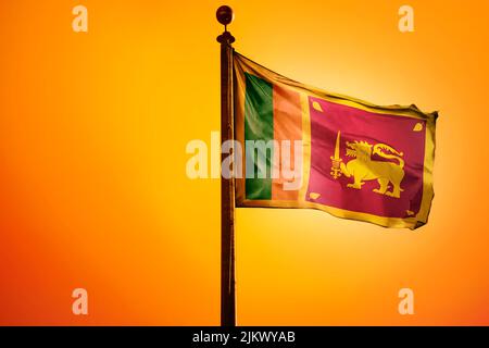 A 3D rendering of the Sri Lanka flag waving in the wind with an orange background Stock Photo