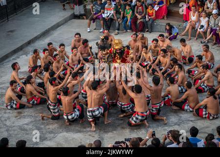 A group of people at the Uluwatu Temple and Kecak Traditional Fire Dance in Bali, Indonesia Stock Photo