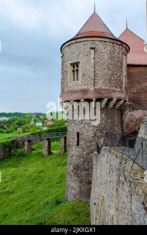 A vertical shot of Corvin Castle tower, also known as Hunyadi Castle or Hunedoara Castle. Romania. Stock Photo