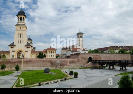 The view of Coronation Cathedral bell tower with St. Michael's Cathedral. Alba Iulia, Romania. Stock Photo