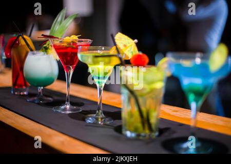 Row of different martini glasses on the counter in a bar Stock Photo