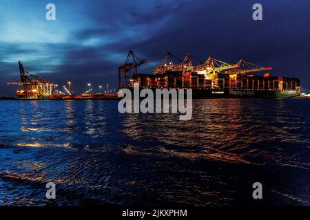 A beautiful view of a huge container ship at the port in Southampton at night Stock Photo