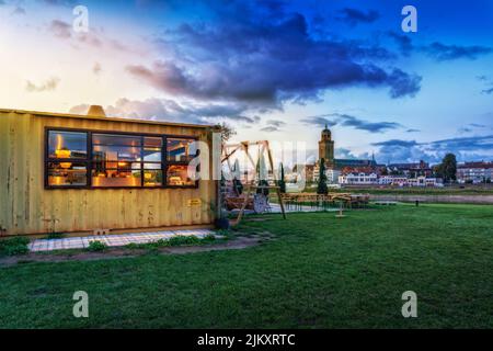 The cafe in the park with the St. Lebuinus Church in the background. Deventer, Netherlands. Stock Photo
