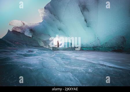 A beautiful view of female in dress posing in the glacier cave in Hofn, Iceland Banque D'Images