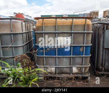 Barrels and containers containing hazardous waste in yard of chemical waste processing works Stock Photo