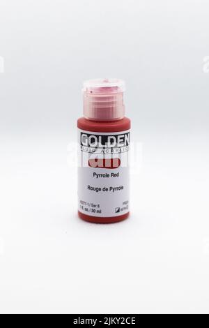 A bottle of Golden red paint on a white background Banque D'Images