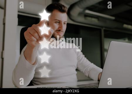 Homme qui donne une note de 5 étoiles pour un service ou un produit en ligne. Banque D'Images