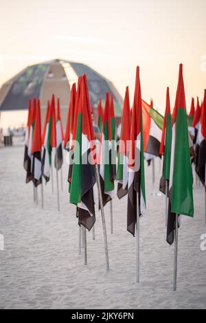 A vertical shot of a bunch of UAE flags on poles on Kite Beach in Dubai Banque D'Images
