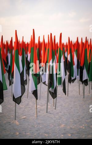 A vertical shot of a bunch of UAE flags on poles on Kite Beach in Dubai Banque D'Images