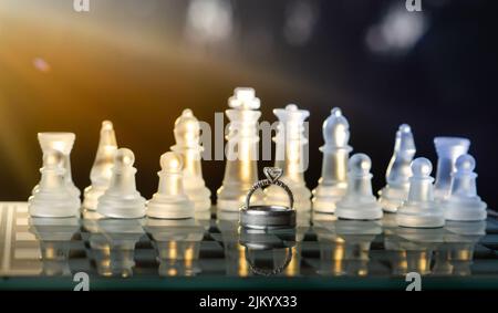 A close-up of rings with chess pieces on background Stock Photo