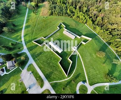 An aerial view of the green landscape, roads, and green trees in Fort Frederick State Park on a sunny day Stock Photo