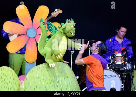 Les chanteurs Siddartha Vargas (R) Jana et Pau d'El Pot petit avec le caractère d'un Dragon au Festival des Jardins de Terramar à Sitges (Barcelone). Le groupe de musique pour enfants 'El pot petit' (le petit pot) s'est produit dans les Jardins de Terramar avant environ 1500 personnes, principalement des garçons et des filles âgés de 3 à 10 ans. 'El pot petit' est un groupe de musique pour enfants bien connu en Catalogne formé par Siddartha Vargas et Helena Bagué (Pau et Jana) avec plusieurs musiciens et personnages tels qu'un dragon ou un millepertuis où ils créent des histoires, dansent et font les enfants s'amuser. Banque D'Images