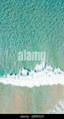 A vertical aerial shot of sea waves Stock Photo