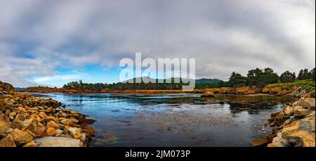 A  calm view of reflective water of Whalers Cove Point Lobos State Reserve Stock Photo