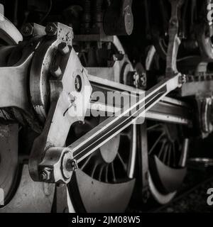 A grayscale shot of a steam train wheel Stock Photo