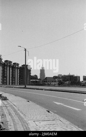 A vertical grayscale shot of an empty street in the city Stock Photo