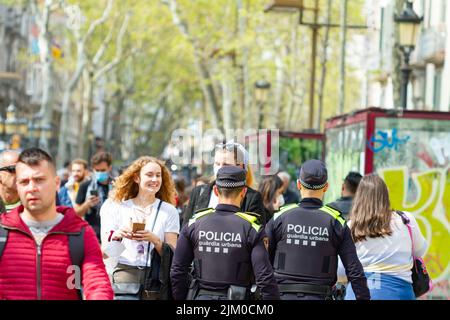 Barcelona, Spain - April 6, 2022: Two policemen patrolling on the Ramblas in Barcelona (Spain), on the most popular street in the city. Stock Photo