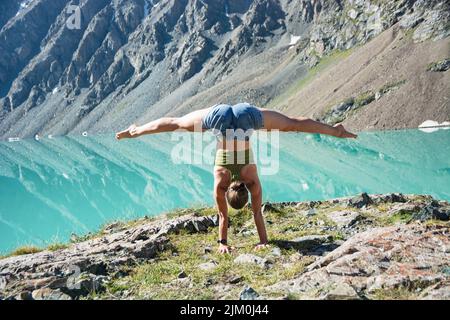 Fille faisant du yoga près de merveilleux paysage de montagne, lac, montagne, pic, monde de beauté. Vue pittoresque près du lac Alakul. Banque D'Images