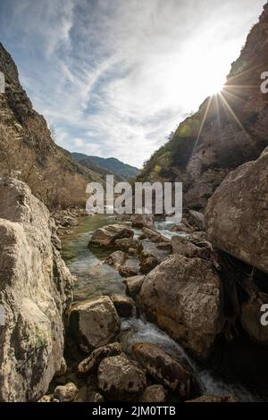 A vertical shot of a mountain stream with rocks in Le Verdon, France Stock Photo