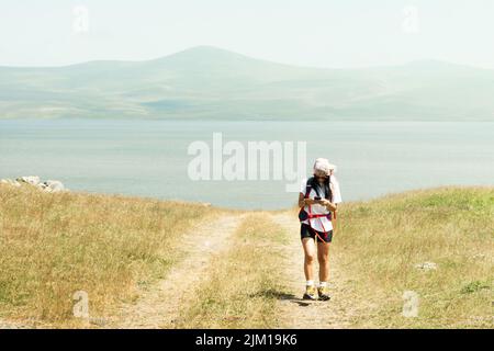 Femme utilisez le téléphone de navigation à l'extérieur pour naviguer sur le sentier de randonnée pour atteindre destination dans les montagnes du caucase Banque D'Images