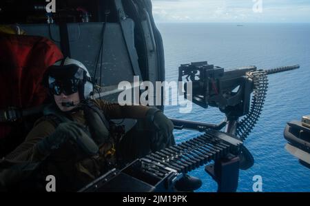 Océan Pacifique. 12th juillet 2022. Naval Aircrewman (hélicoptère) 2nd classe Tyler Williamson, d'Inola, Oklahoma, vole dans un MH-60s Seahawk affecté aux Golden Falcons de l'Escadron de combat de la mer (HSC) 12, embarqué à bord du seul porte-avions déployé par l'avant de la marine américaine, l'USS Ronald Reagan (CVN 76). Le HSC 12, établi à l'origine sous le nom d'Escadron anti-sous-marin d'hélicoptères (HS) 2 sur 7 mars 1952, est le plus ancien escadron d'hélicoptères de la Marine opérationnelle. Ronald Reagan, le navire amiral du Carrier Strike Group 5, fournit une force prête au combat qui protège et défend les États-Unis, un Banque D'Images