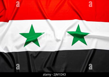 Drapeau vague de la Syrie pour une vue d'ensemble en arrière-plan Banque D'Images