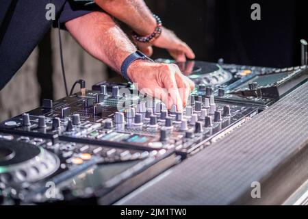 Jouer Dj disco house electro progressive music au concert. Les mains sur l'équipement de DJ Banque D'Images