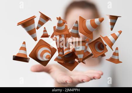 Une vue des icônes de cônes de trafic orange et blanc flottant dans la paume de la femelle Banque D'Images