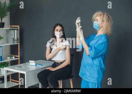 Médecin préparer le vaccin Covid -19 avant l'injection. Injection de vaccin contre la grippe sur le bras. Coronavirus, vaccin Covid-19. Banque D'Images