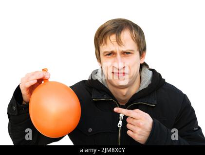 Un jeune homme insatisfait tient un ballon Banque D'Images