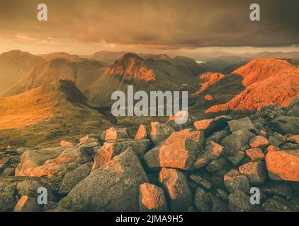 Coucher de soleil près du sommet de la plus haute montagne d'Angleterre, Scafell Pike, en regardant vers Great Gable à proximité dans le parc national de Lake District. Banque D'Images