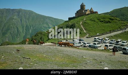 Stepantsminda, Géorgie montrant l'église de la Trinité de Gergeti, Tsminda Sameba ou l'église de la Sainte Trinité, près du village de Gergeti vue extérieure en plein jour. Banque D'Images