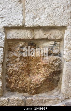 A vertical shot of the handprint of Jesus n the stone in Jerusalem Stock Photo