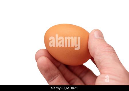 Œuf à la main et fond d'œuf pour la cuisson, mise au point douce Banque D'Images