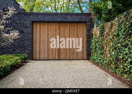 Grande porte de garage et allée en béton à l'avant Banque D'Images