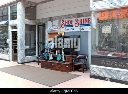 Un homme de cirage de chaussures afro-américain plus âgé se repose dans le 5th Street Arcade, une arcade commerciale intérieure historique de Cleveland, Ohio, États-Unis Banque D'Images