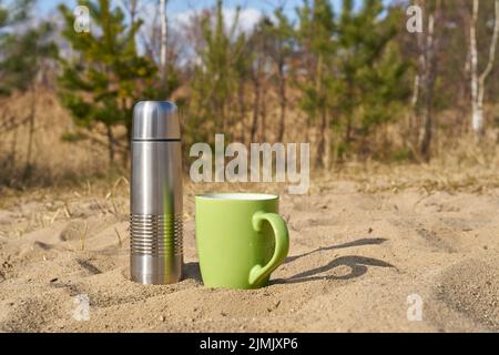 Pique-niquez avec des thermos et une tasse le jour du printemps dans la nature Banque D'Images